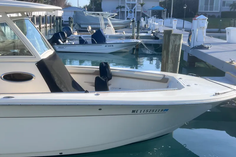 Slide: The Image of 2015 Scout 255 LXF boat docked at marina, calm water, sunny day. - 33