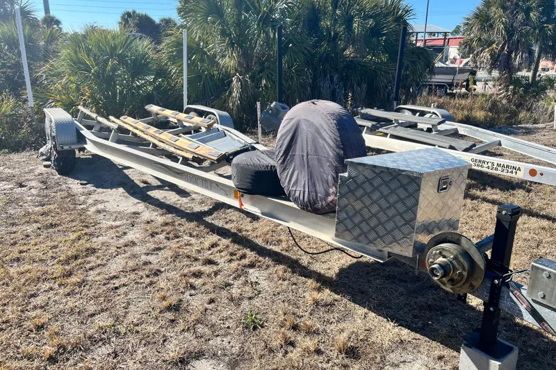 Slide: The Image of Boat trailer for 2015 Scout 255 LXF, parked outdoors near palm trees. - 35