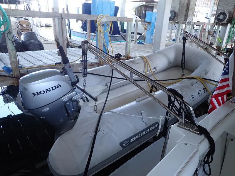 Slide: The Image of Inflatable boat with Honda motor docked on Carver 370 Voyager, 1996 model. - 20