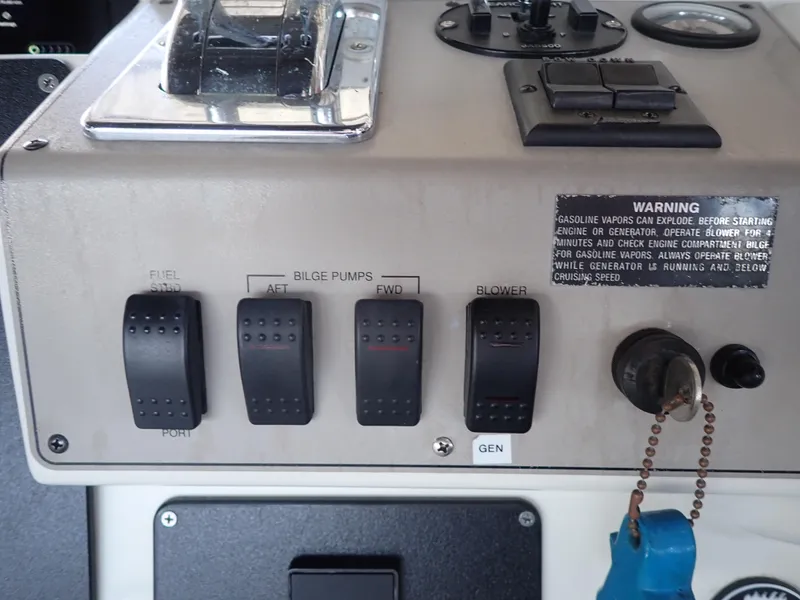 Slide: The Image of Control panel of a 1996 Carver 370 Voyager boat with switches and warning label. - 29