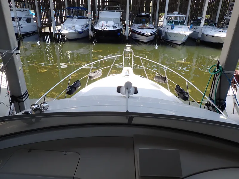 Slide: The Image of 1996 Carver 370 Voyager docked among other boats in a marina. - 33