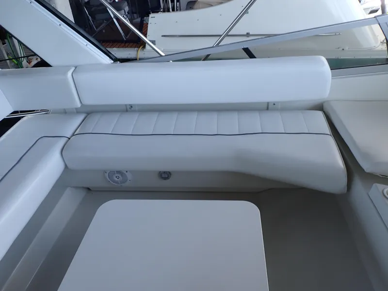 Slide: The Image of Interior seating of 1996 Carver 370 Voyager yacht, featuring white cushioned benches. - 35
