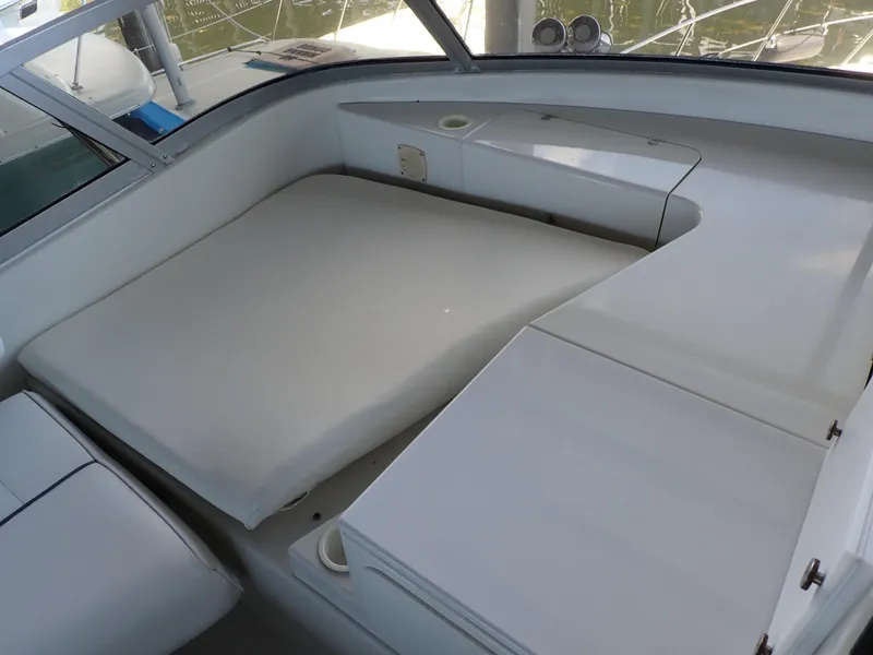 Slide: The Image of 1996 Carver 370 Voyager interior seating area with cushioned bench and storage compartments. - 36