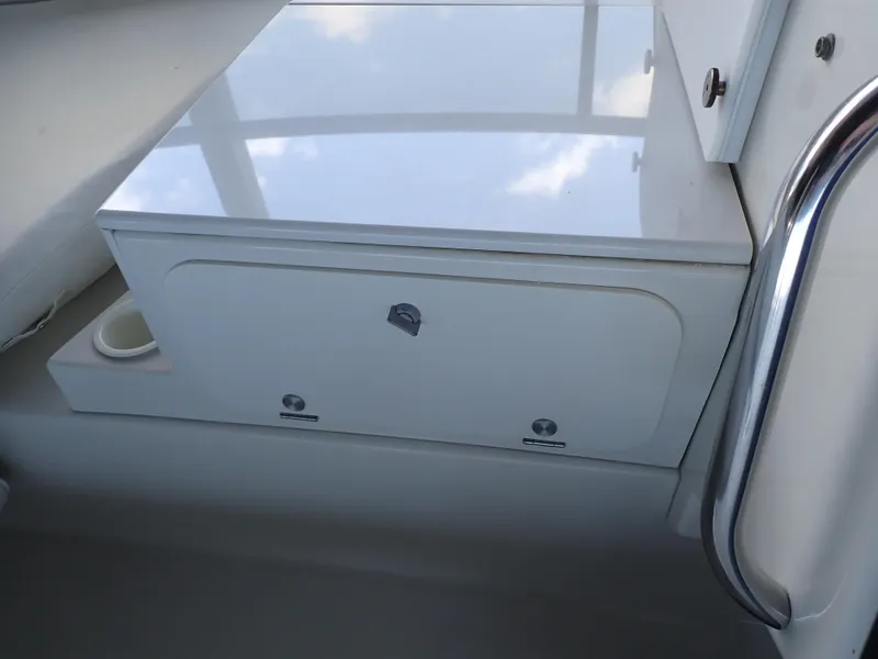 Slide: The Image of 1996 Carver 370 Voyager interior storage compartment with sleek white finish and metal handle. - 37