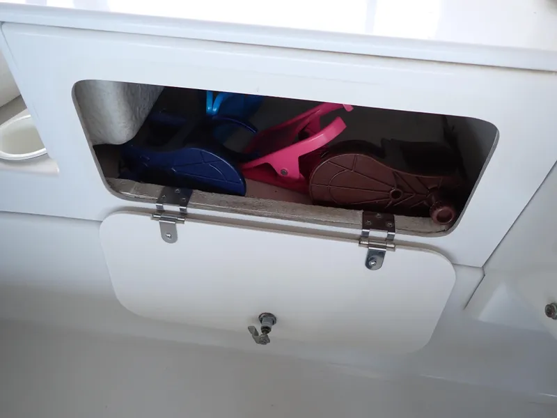 Slide: The Image of Storage compartment on 1996 Carver 370 Voyager boat with colorful flippers inside. - 38