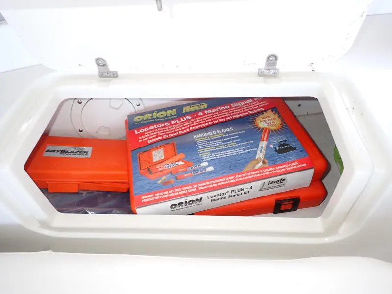 Slide: The Image of Safety equipment storage on a 1996 Carver 370 Voyager, featuring marine signal kit. - 40