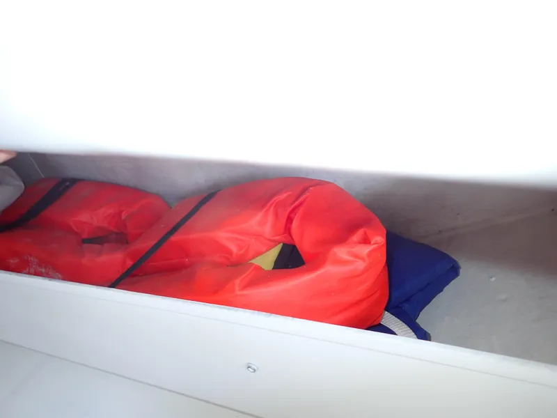 Slide: The Image of Life jackets stored in a compartment on a 1996 Carver 370 Voyager boat. - 42