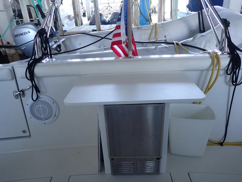 Slide: The Image of 1996 Carver 370 Voyager boat deck with American flag and Honda outboard motor. - 48