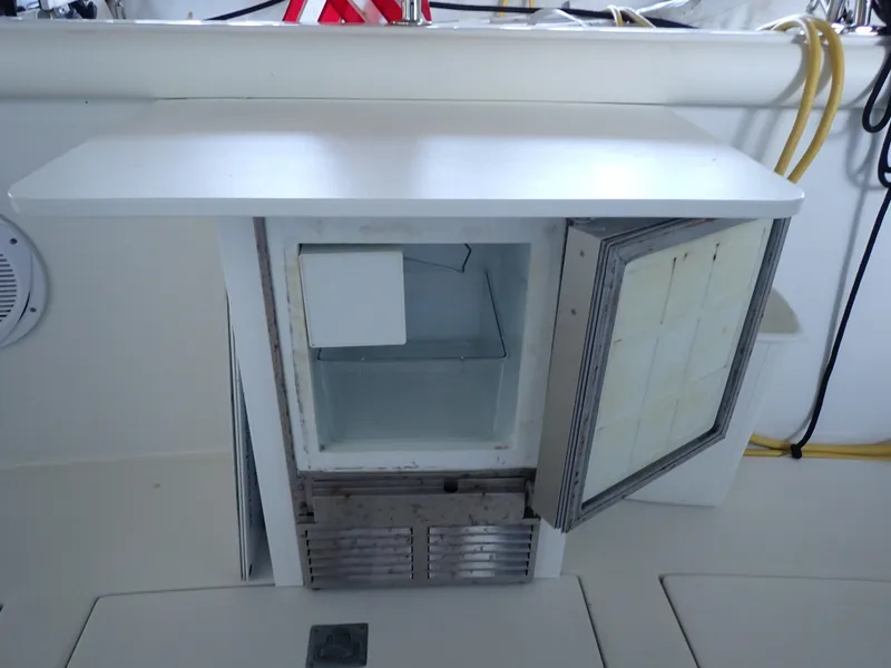 Slide: The Image of Open mini fridge on 1996 Carver 370 Voyager boat deck. - 49