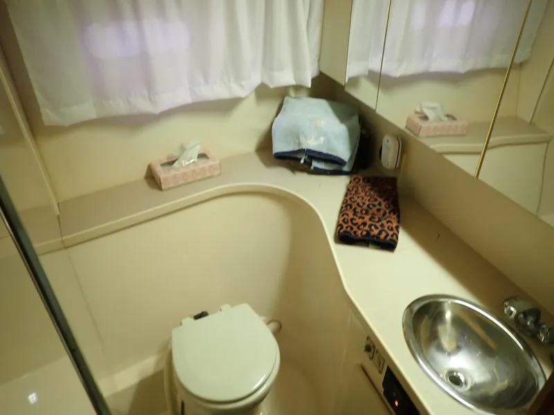 Slide: The Image of Bathroom interior of 1996 Carver 370 Voyager yacht with sink and toilet. - 13