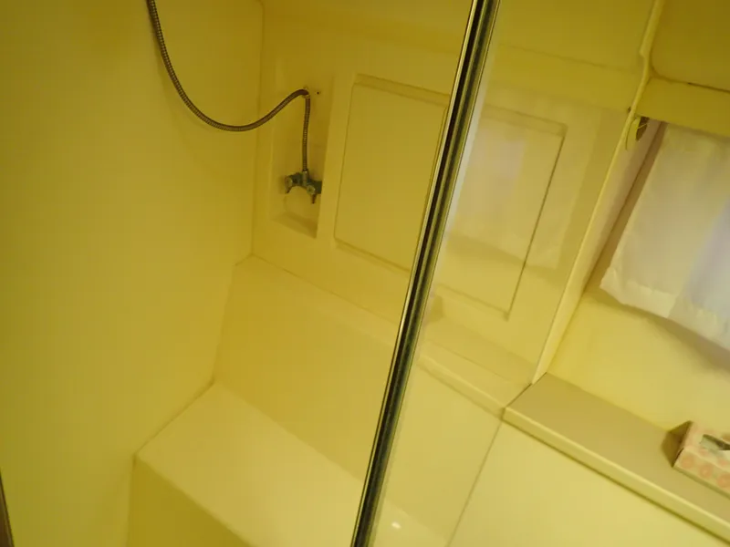 Slide: The Image of 1996 Carver 370 Voyager bathroom with shower, yellow interior, and curtain. - 14