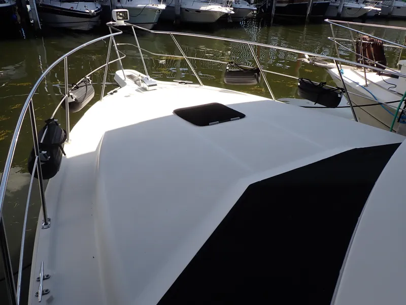 Slide: The Image of 1996 Carver 370 Voyager yacht deck with railing, docked in marina. - 15
