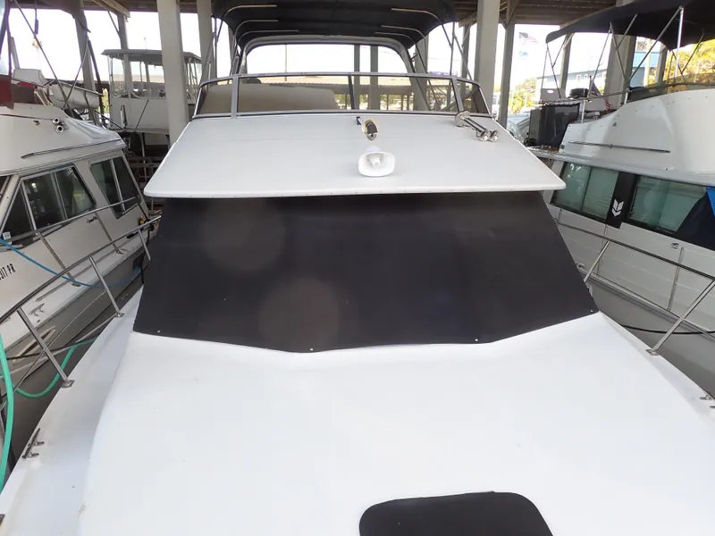 Slide: The Image of 1996 Carver 370 Voyager yacht docked in a marina, front view. - 16