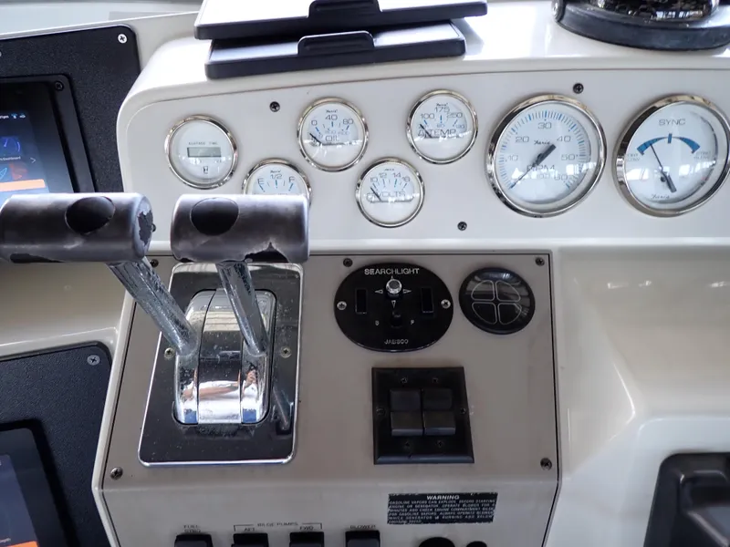 Slide: The Image of Control panel of a 1996 Carver 370 Voyager boat with gauges and levers. - 24
