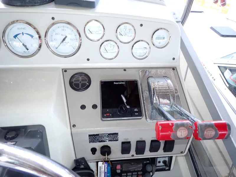 Slide: The Image of Control panel of a 1996 Carver 370 Voyager boat with gauges and throttle levers. - 25