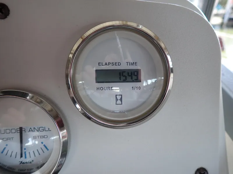 Slide: The Image of Elapsed time gauge on 1996 Carver 370 Voyager boat dashboard, showing 1549 hours. - 32