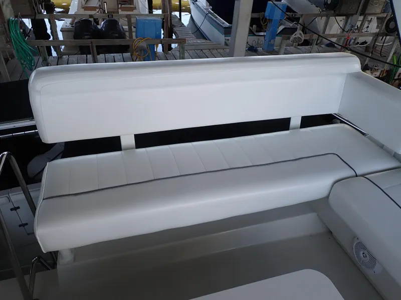 Slide: The Image of White seating on a 1996 Carver 370 Voyager boat, docked in a marina. - 43