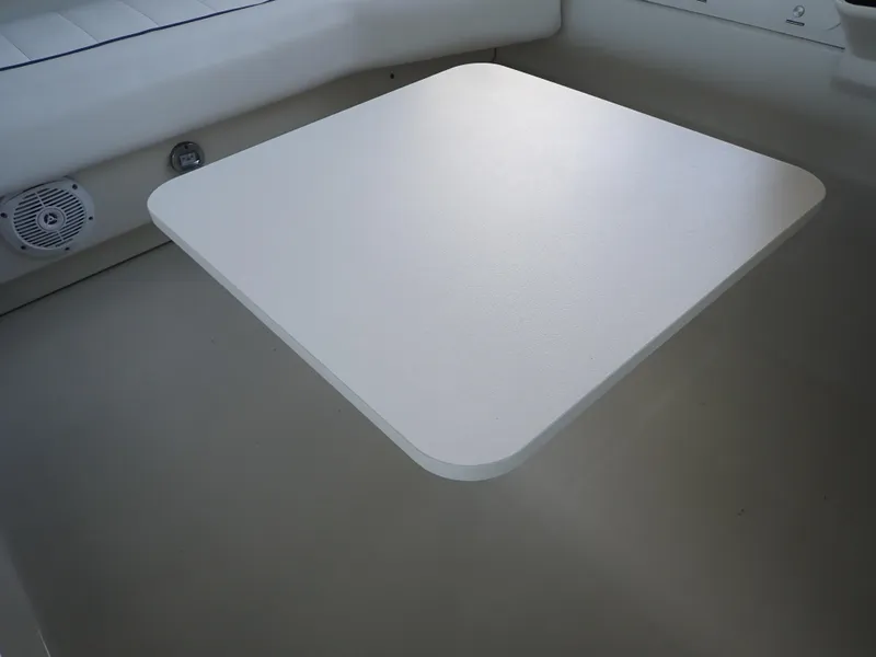 Slide: The Image of White table on 1996 Carver 370 Voyager boat interior, with speaker and seating. - 44