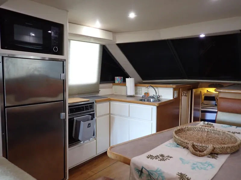 Slide: The Image of Interior of 1996 Carver 370 Voyager yacht with kitchen and dining area. - 7