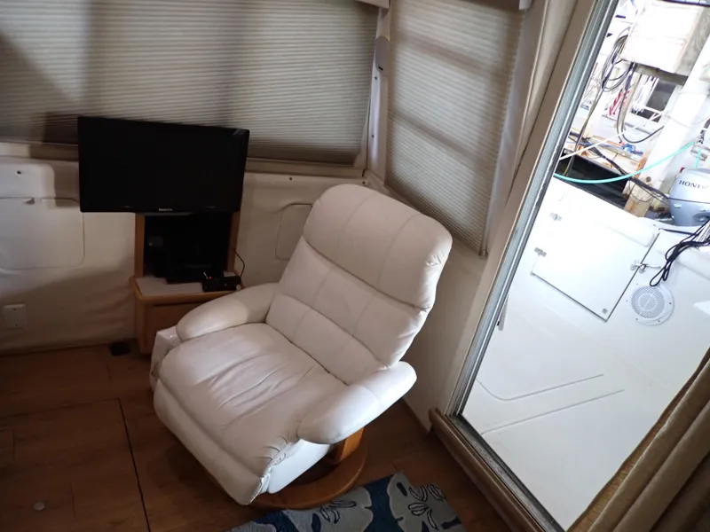 Slide: The Image of Interior of 1996 Carver 370 Voyager with white recliner and TV. - 9