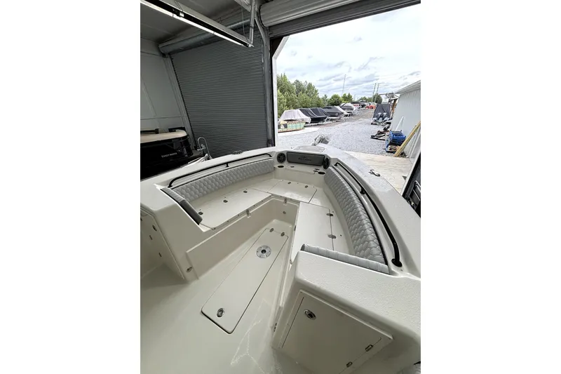 Slide: The Image of 2026 Sea Chaser 30 HFC CC boat interior with cushioned seating and storage compartments. - 10