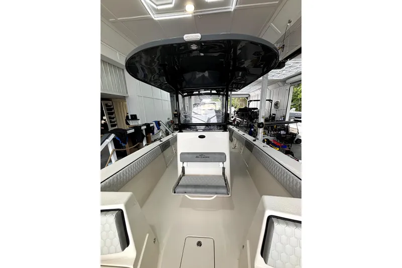 Slide: The Image of 2026 Sea Chaser 30 HFC CC boat interior with seating and helm station. - 11