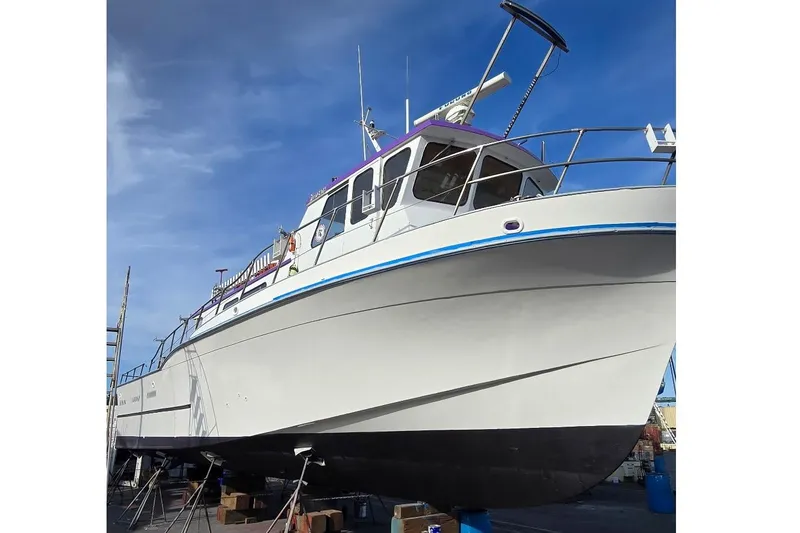 Slide: The Image of 1978 Uniflite 50 boat on dry dock, showcasing its sleek design and sturdy build. - 13
