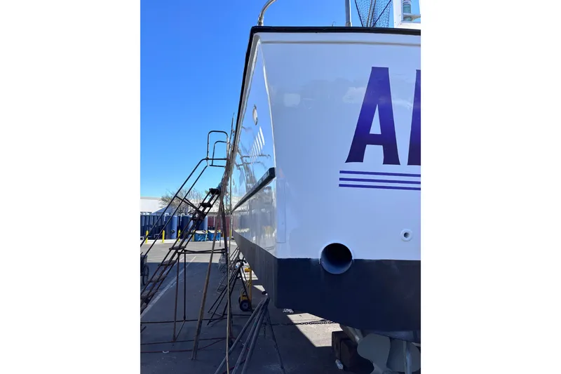 Slide: The Image of 1978 Uniflite 50 boat in dry dock, side view with clear blue sky. - 15