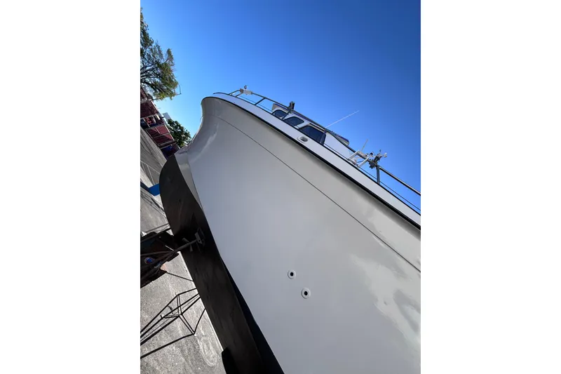 Slide: The Image of 1978 Uniflite 50 boat on dry dock, viewed from below against clear blue sky. - 16