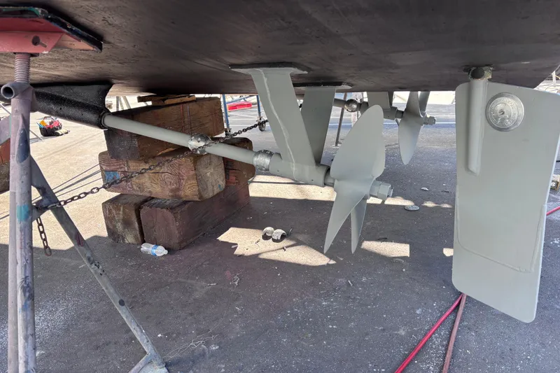 Slide: The Image of 1978 Uniflite 50 boat underside showing propellers and rudders on dry dock. - 17