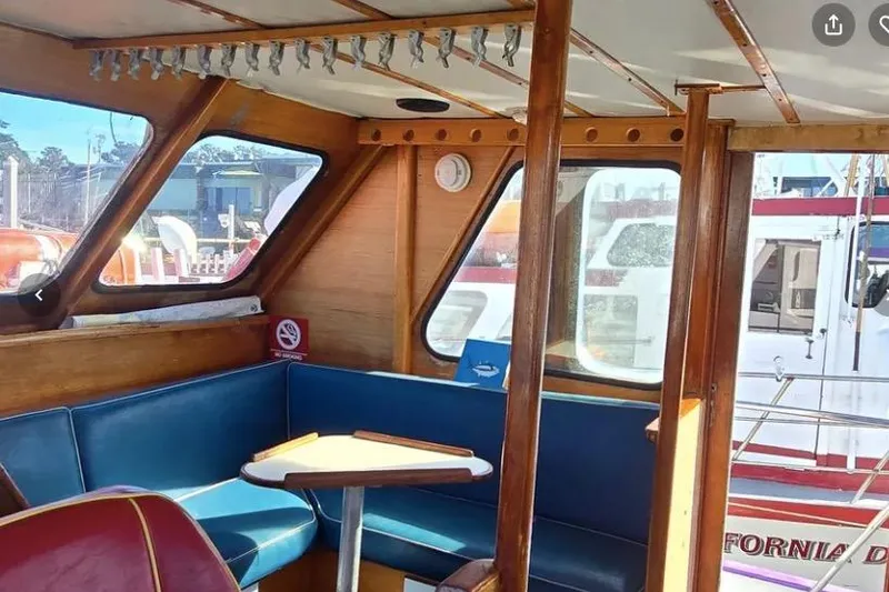 Slide: The Image of 1978 Uniflite 50 boat interior with blue seating and wooden accents. - 7