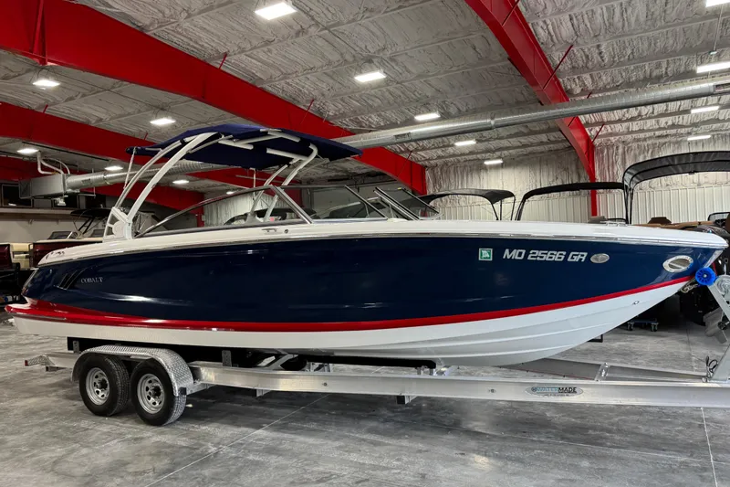 The Image of 2017 Cobalt A28 boat on trailer in indoor showroom with red beams. - 1