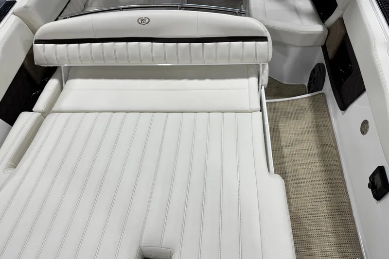 Slide: The Image of 2017 Cobalt A28 boat interior with white cushioned seating and beige flooring. - 11