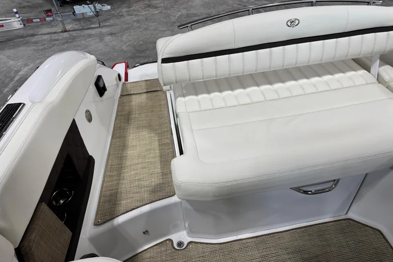 Slide: The Image of 2017 Cobalt A28 boat interior with white leather seating and woven flooring. - 13