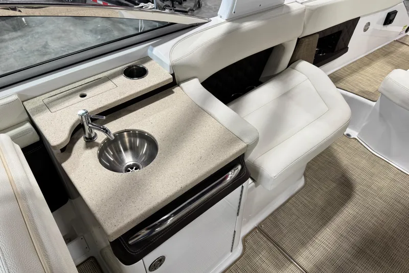 Slide: The Image of 2017 Cobalt A28 boat interior with sink and seating area. - 14