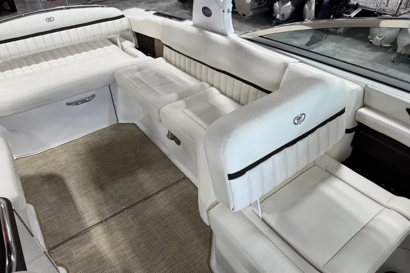 Slide: The Image of 2017 Cobalt A28 boat interior with white leather seating and beige carpet flooring. - 15