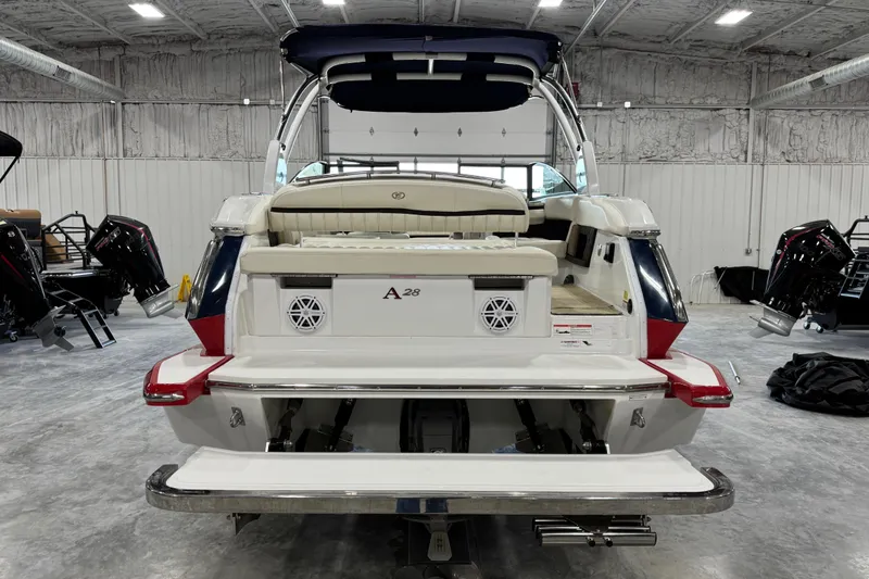 Slide: The Image of 2017 Cobalt A28 boat in a showroom, showcasing rear seating and swim platform. - 5