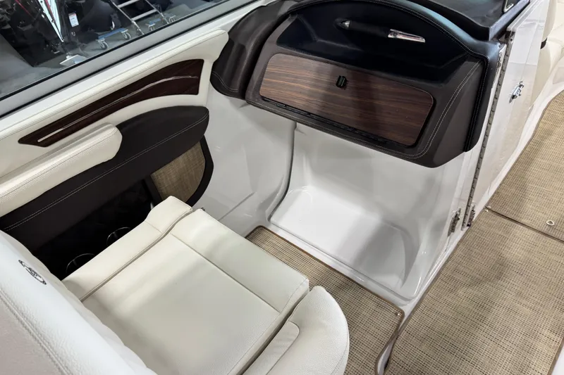 Slide: The Image of 2017 Cobalt A28 boat interior with white seating and wood accents. - 8
