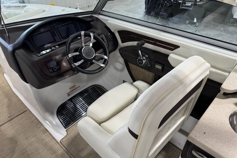 Slide: The Image of 2017 Cobalt A28 boat cockpit with steering wheel and control panel. - 9