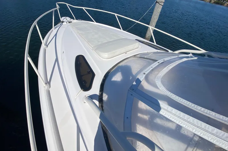 Slide: The Image of 2001 Intrepid 377 Walkaround boat deck with railing, docked on calm water. - 12