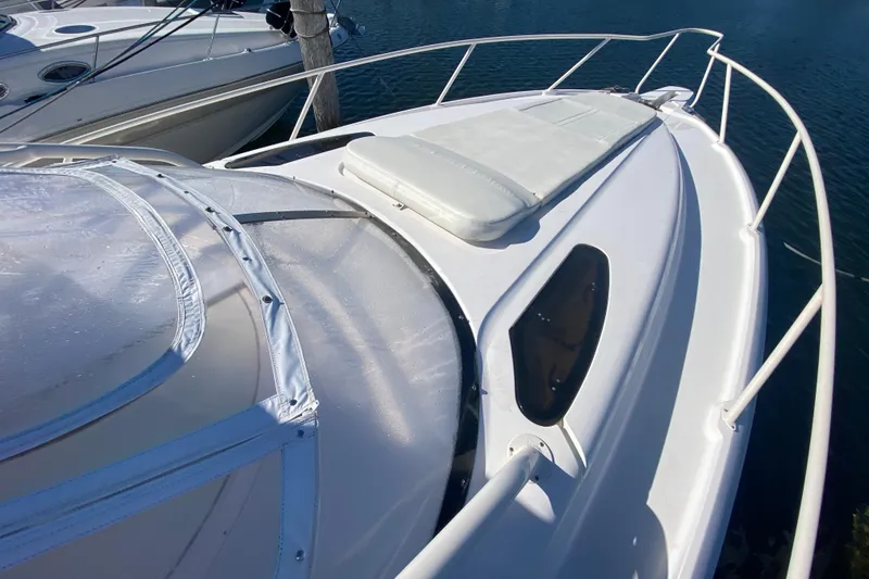 Slide: The Image of 2001 Intrepid 377 Walkaround boat deck with cushioned seating and railing. - 13