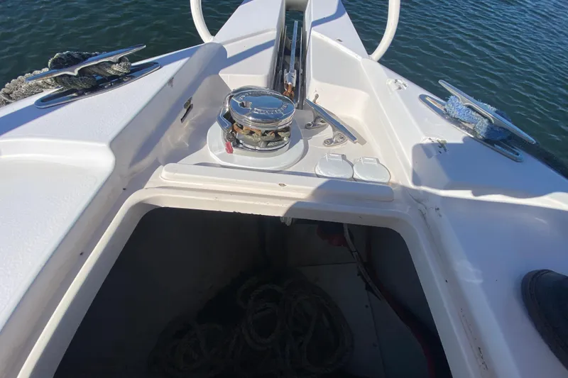 Slide: The Image of 2001 Intrepid 377 Walkaround boat deck with anchor storage and winch. - 17