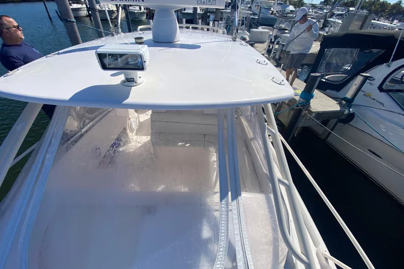 Slide: The Image of 2001 Intrepid 377 Walkaround boat docked at marina with people nearby. - 18