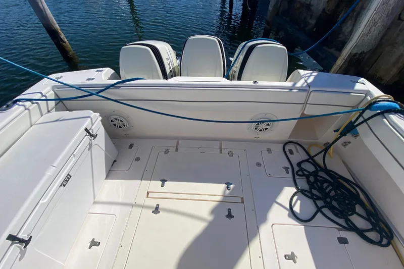 Slide: The Image of 2001 Intrepid 377 Walkaround boat deck with outboard motors and docked ropes. - 21