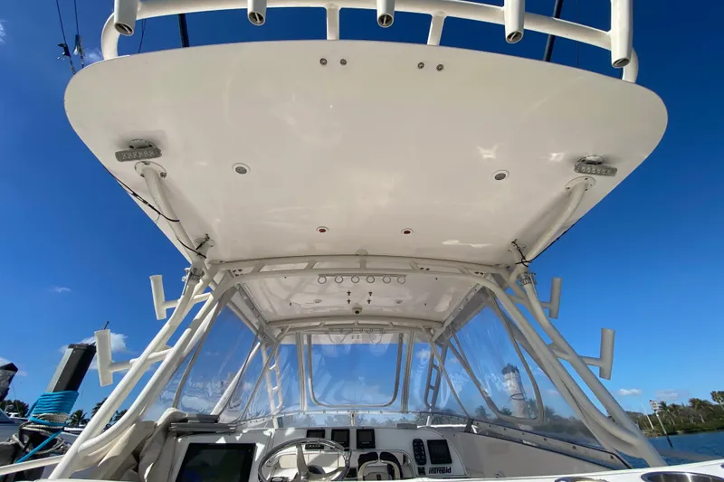 Slide: The Image of 2001 Intrepid 377 Walkaround boat helm with clear canopy and blue sky background. - 22