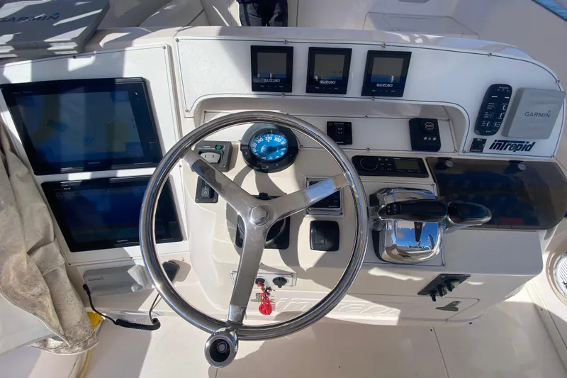 Slide: The Image of 2001 Intrepid 377 Walkaround helm with steering wheel, gauges, and navigation equipment. - 25