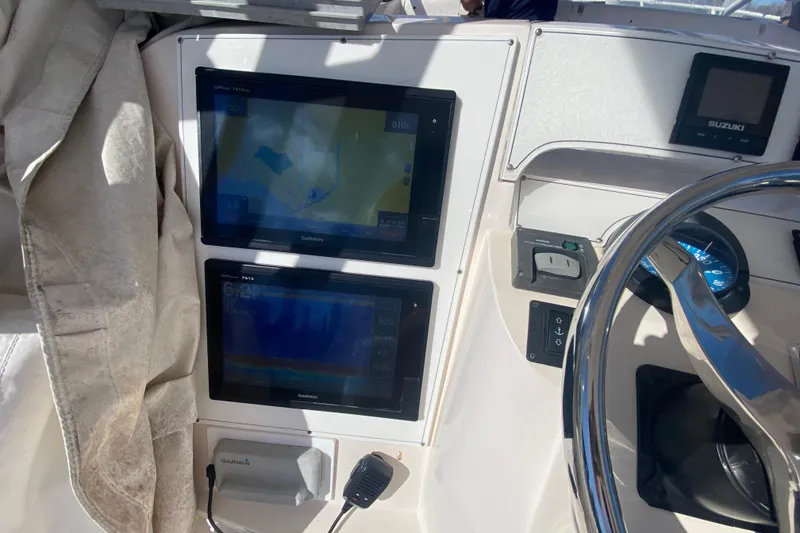 Slide: The Image of 2001 Intrepid 377 Walkaround helm with Garmin navigation displays and steering wheel. - 26