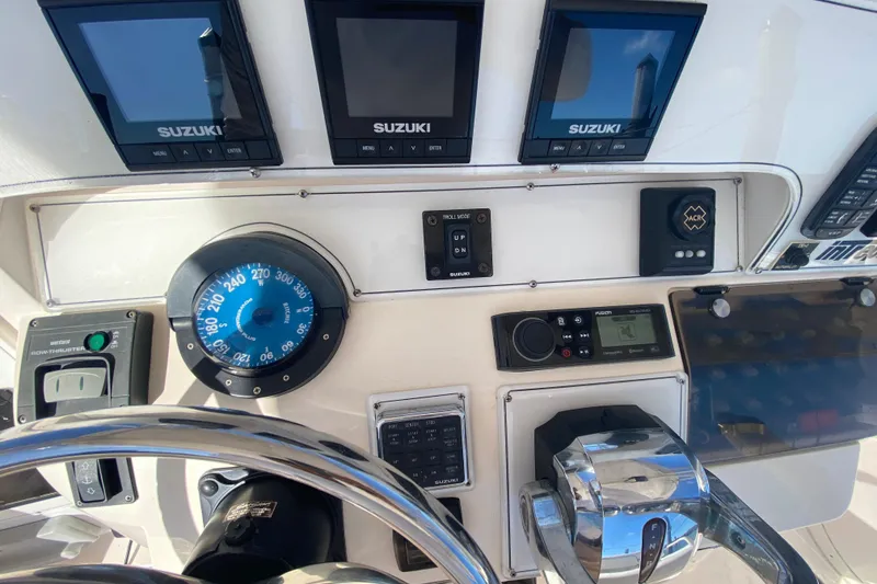 Slide: The Image of Control panel of a 2001 Intrepid 377 Walkaround boat with Suzuki displays. - 29