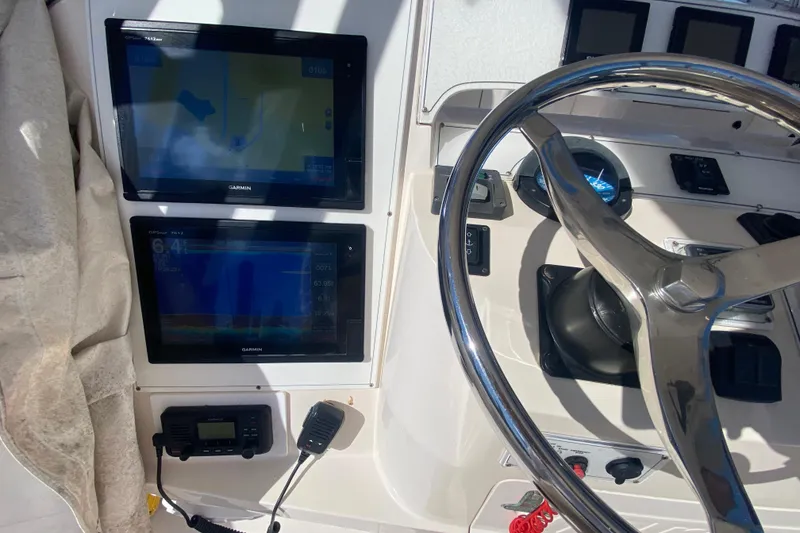 Slide: The Image of 2001 Intrepid 377 Walkaround helm with Garmin displays and steering wheel. - 30