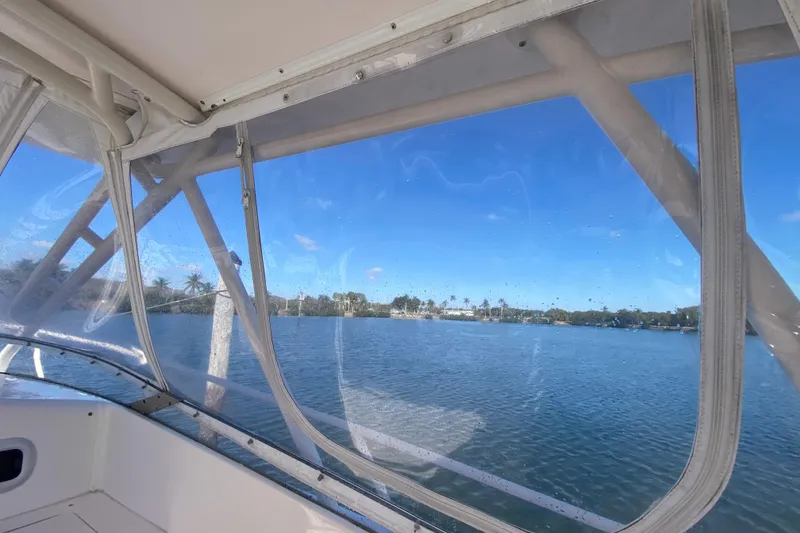 Slide: The Image of Interior view from a 2001 Intrepid 377 Walkaround boat, overlooking a serene waterway. - 32